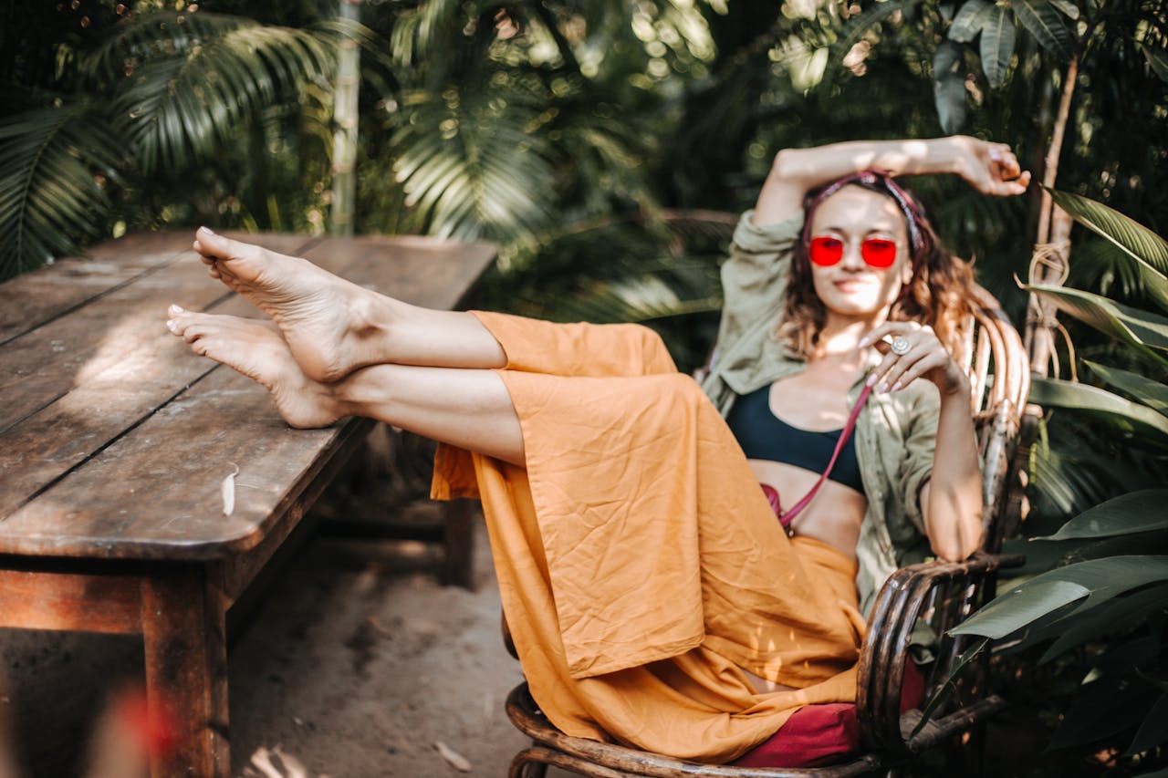 Woman relaxing in a tropical outdoor setting with lush greenery.